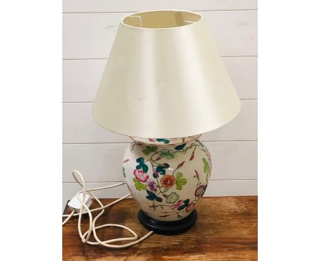 A Chinese lamp base with cream shade and wooden base 