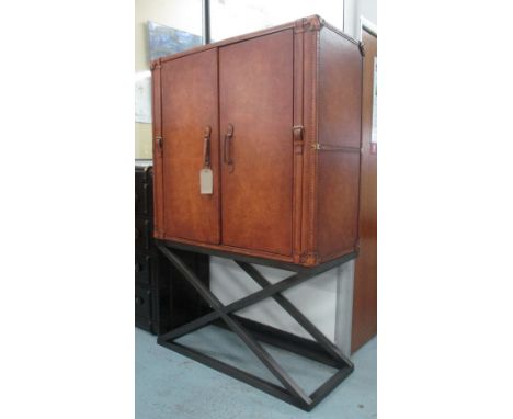 PULLMAN DRINKS CABINET, leather trunk on metal stand, 121cm W x 51cm D x 186cm H.