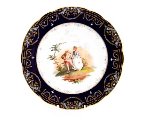 A Continental cabinet plate, painted with a scene of two figures, gilt and enamel border