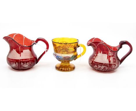 A pair of etched ruby flash glass jugs; and an amber glass mug (3)
