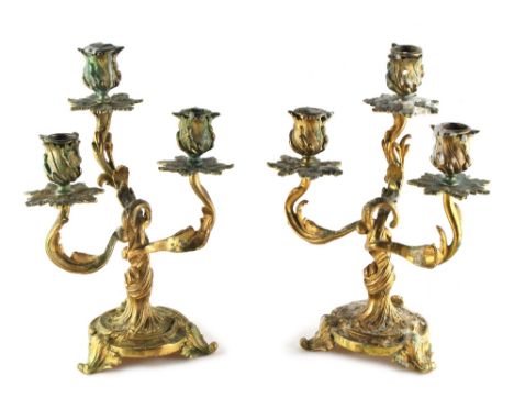 Property of a deceased estate - a pair of 19th century French Louis XV style ormolu three light candelabra of rocaille form, 
