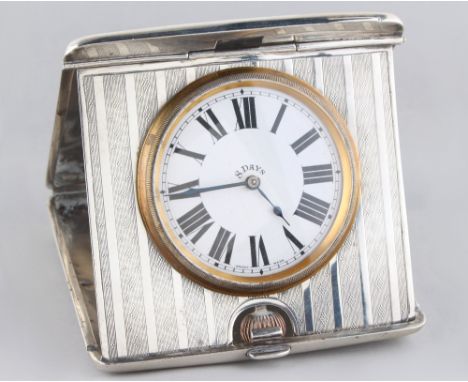 Property of a gentleman - an early 20th century silver cased folding travel clock, the case with engine turned decoration, wi