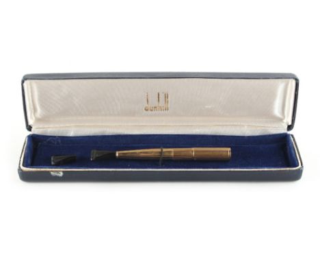 Property of a lady - a Dunhill 18ct yellow gold cigarette holder, French marks, with black plastic tip &amp; spare tip, appro