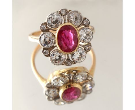 A certificated Burmese ruby &amp; diamond flowerhead cluster ring, the oval cut ruby weighing 1.40 carats, with approximately