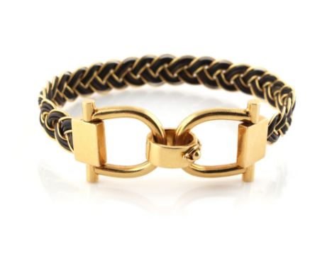 A yellow gold (tests 18ct) bangle of braided form, possibly with elephant hair, the clasp marked 750, approximately 19.4 gram