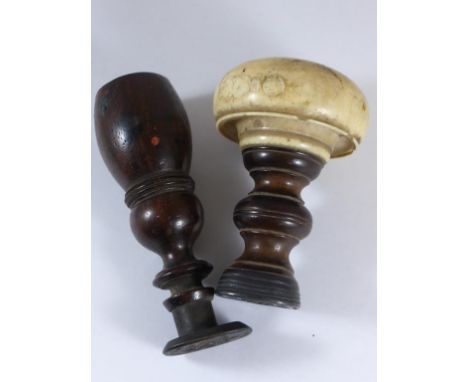 2 DESK SEALS, ONE WITH TURNED WOODEN HANDLE THE OTHER A TURNED IVORY HANDLE AF