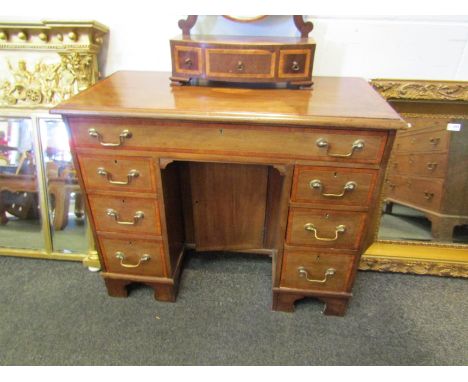 A 19th Century mahogany inlaid kneehole desk, seven drawers with central cupboard door on bracket feet. 74cm x 88cm x 41cm