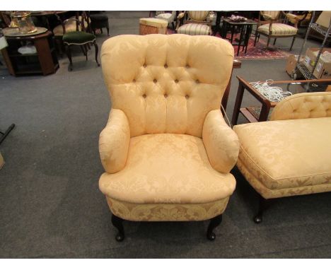 A modern gold velour button back armchair on cabriole front legs