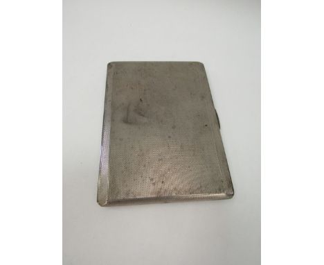 A silver engine turned cigarette case with monogrammed interior