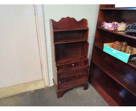 A George III revival mahogany waterfall bookshelf with single drawer and cupboard on bracket feet. 97cm x 45.5cm x 26cm  