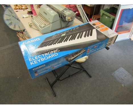 A Casio CTK-1150 keyboard with stand and stool
