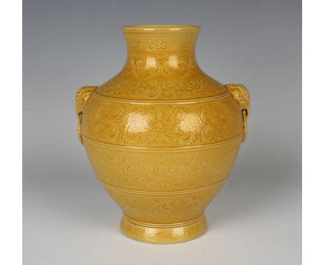 A Chinese yellow enamelled biscuit porcelain vase, mark of Qianlong but 20th century or later, of hu form, incised with bands