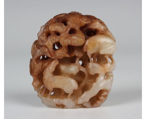 A Chinese Ming style jade finial, carved and pierced with two horses and a tiger amidst rocks, branches and clouds, height 4.