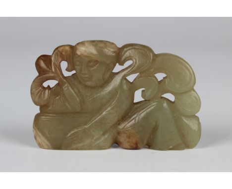 A Chinese celadon jade carving, carved and pierced with a seated boy, length 5.7cm.Buyer’s Premium 29.4% (including VAT @ 20%