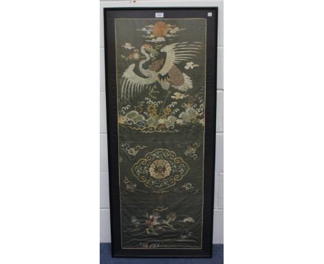 A Chinese silk embroidered panel, late Qing dynasty, worked in coloured threads with a red-capped crane above crashing waves,