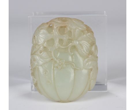 A Chinese pale celadon jade pendant, probably 20th century, carved as two pumpkins enveloped in their own vine and leaves, le