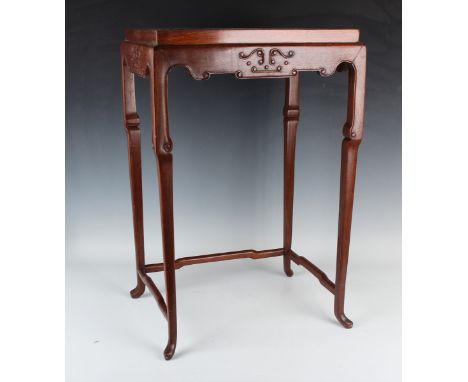 A Chinese hardwood occasional table, 20th century, the rectangular top above a carved scroll apron, on shouldered tapering le