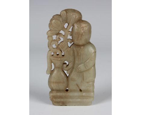 A Chinese pale celadon jade carving, probably 20th century or later, carved and pierced with a boy standing beside a flower-c