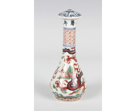 A Chinese Ming style wucai porcelain fly whisk handle, mark of Wanli but probably 20th century, painted with dragons, vapours