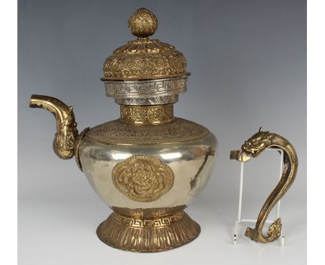 A Tibetan brass mounted teapot and cover, late 19th/early 20th century, the silvered globular body applied with embossed bras