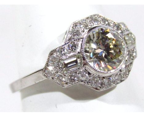 An 18ct gold Art Deco diamond ring, the central stone approximately 1ct surrounded by smaller diamonds on a part pierced whit