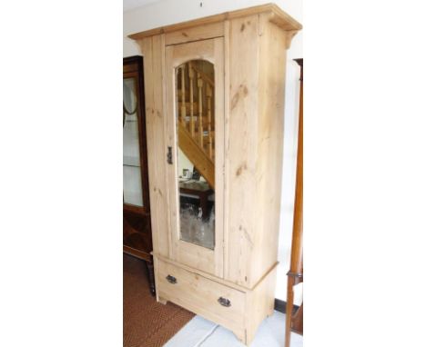 An early 20thC stripped pine single wardrobe, with shaped mirror above single drawer with heavy Art Nouveau handles, 198cm hi