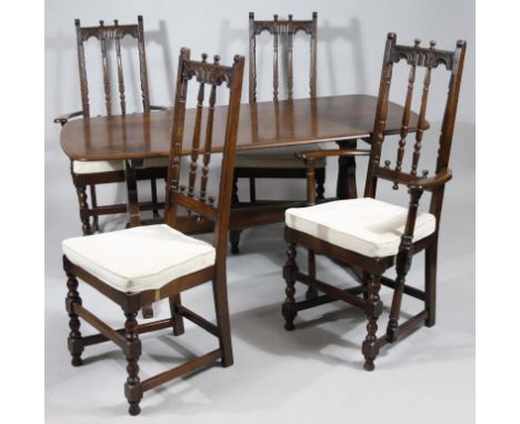 A Ercol dark wood dining table, with oblong top, 74cm high, 150cm wide, 76cm deep, together with four chairs with removable c