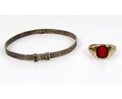 An Elizabeth II child's silver bangle, 6cm wide, and a signet ring with polished stone. (2)