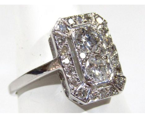 An 18ct gold Art Deco design ring, with approximately 0.8ct central diamonds, on a plain shank, 3.5g all in.