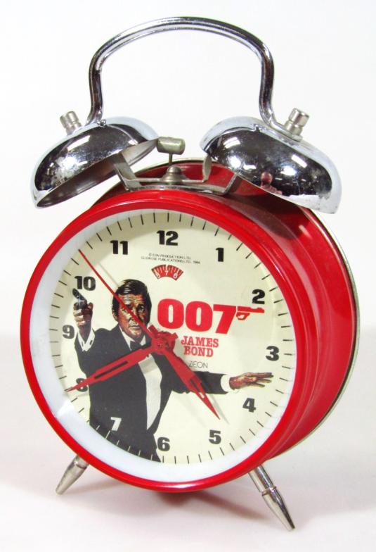 An EON Zeon James Bond 007 alarm clock, with elaborate bell top red