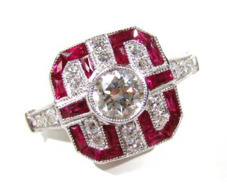 An Art Deco style 18ct gold diamond and ruby ring, with a cross over pattern and central stone on a part pierced white metal 