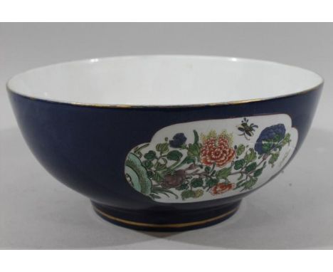 An early 18thC Kangxi style Chinese porcelain bowl, of large proportion, in powder blue with an upper gilt banding, the main 