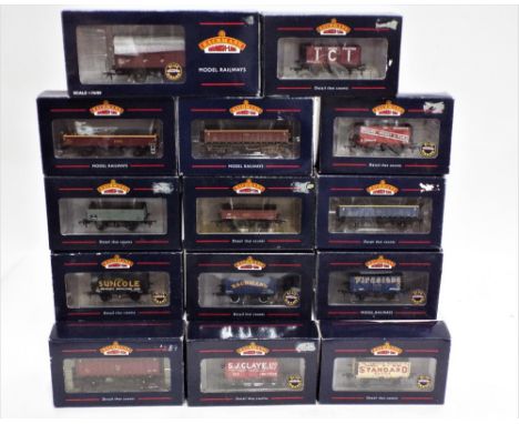 Fourteen 00 gauge boxed Bachmann rolling stock, 7 plank wagons, open box mineral wagons, 5 plank wagons, 45 tonne mineral wag