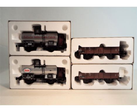 Four 0 gauge boxed scale model rolling stock, two low sided wagons and two tankers 