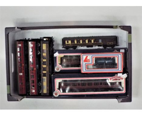 Seven Hornby 00 gauge coaches, three boxed Bachmann coaches and a Lima dairy tanker 