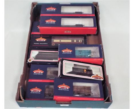Eleven Bachmann 00 gauge well wagons, coaches, scrap wagons etc  
