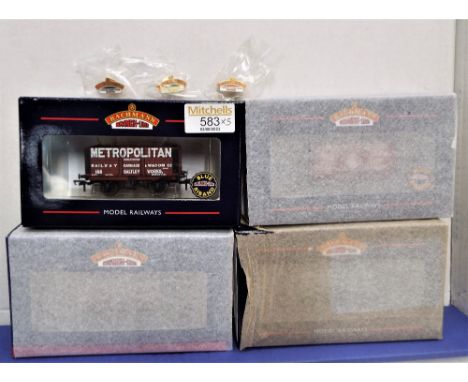 Four 00 gauge boxed Bachmann collectors club plank wagons and three collectors club badges 