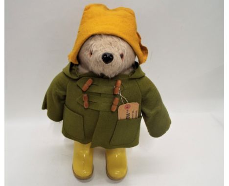 Paddington Bear, made in England, Gabrielle design, yellow boots (Dunlop Wellingtons) and hat, green duffle coat, height appr