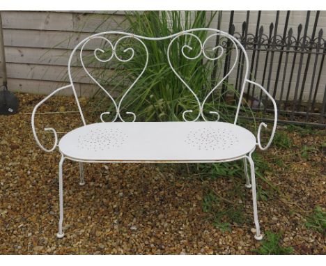 A white painted two seater garden bench