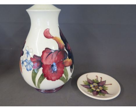 A late 20th century Moorcroft pottery lamp of ovoid form decorated with floral sprays -Height 22 cm and a small dish - Diamet