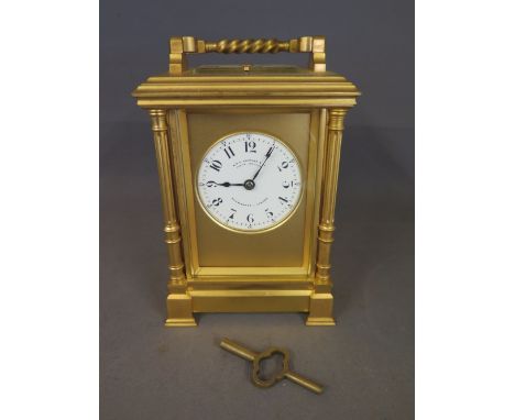 A good quality gilt brass French Carriage clock striking on a gong with repeat and platform movements - the 5 cm dial signed 