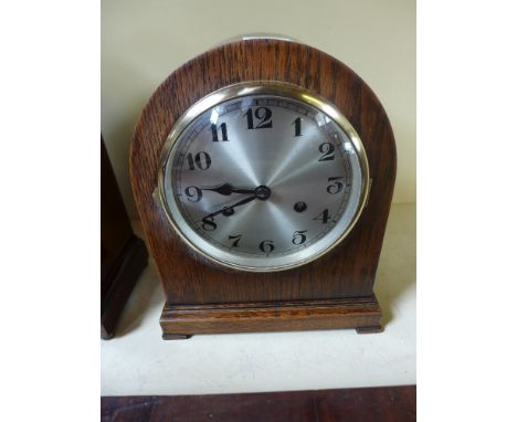 An eight day striking mantel clock in an oak case 
Condition report: Working with key