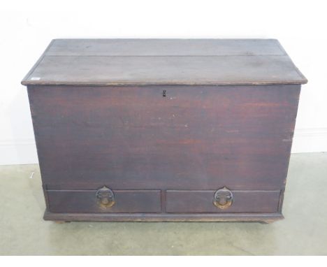 A hinged lidded trunk with two drawers below
