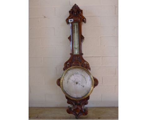 A 19th century hand carved walnut silver dialed Aneroid barometer - maker Harry Roberts, South Kensington - Height 80 cm 