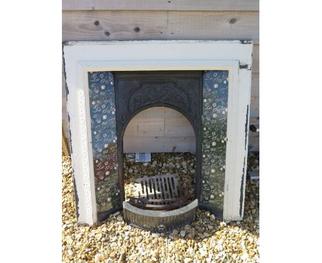 A late Victorian Art Nouveau style cast iron fire surround with original inset tiles