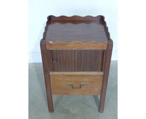 A mahogany tray commode with sliding tambour door over commode base, shaped gallery and raised on square supports