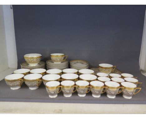 A Minton porcelain Ball tea service of sixty three pieces including twelve coffee cups, twelve tea cups, sugar bowl, two cake