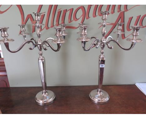 A pair of five light nickel plated candelabra on circular bases - Height 62 cm