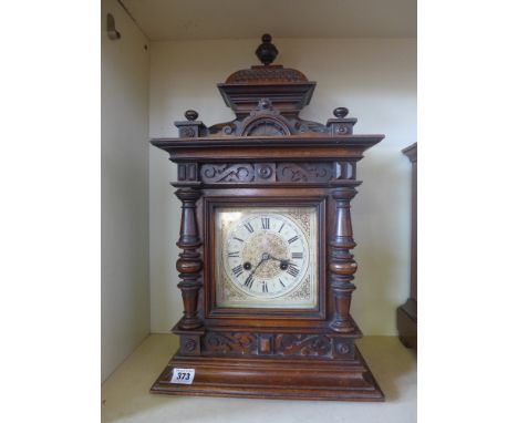 A carved walnut Junghams striking mantel clock - Height 57 cm 