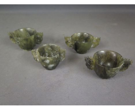 Four Oriental carved green spinach steatite twin handle miniature libation cups - Height 4 cm x Width 8 cm 
Condition report: